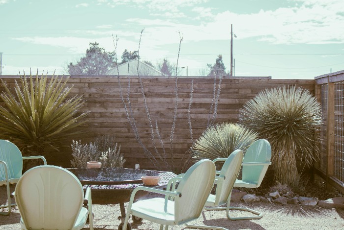 Create a cozy outdoor oasis: Tips for arranging patio furniture around a fire pit for the perfect gathering spot.